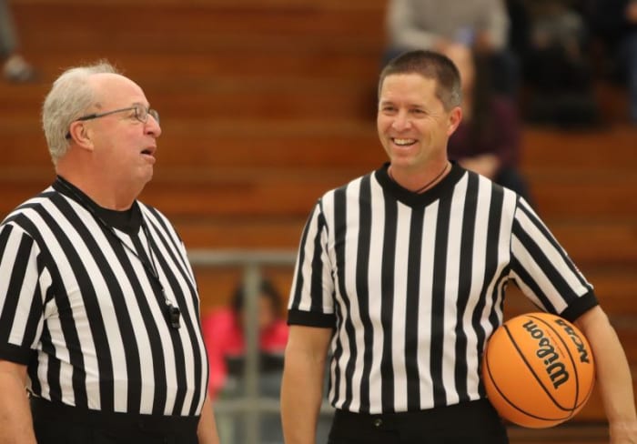 Officials Rick Hutchins of Riverside and Dan Van Gorp of Redlands share a light moment.